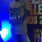 Festus Nwaomucha displaying his award
