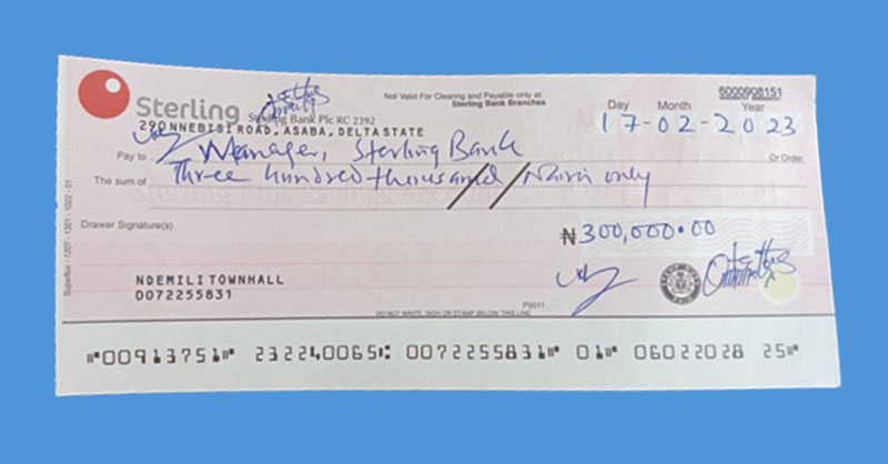 A cheque of N300,000 donated by Ndemili Town Hall Forum to Humphrey Ossai